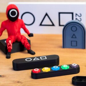 Gongi game in a long box (sorter) in black and white.